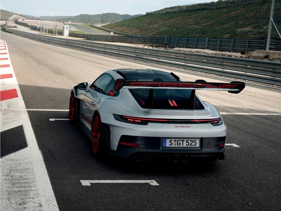 The Porsche 911 GT3 RS on the starting line on a race track. View of rear end from behind.